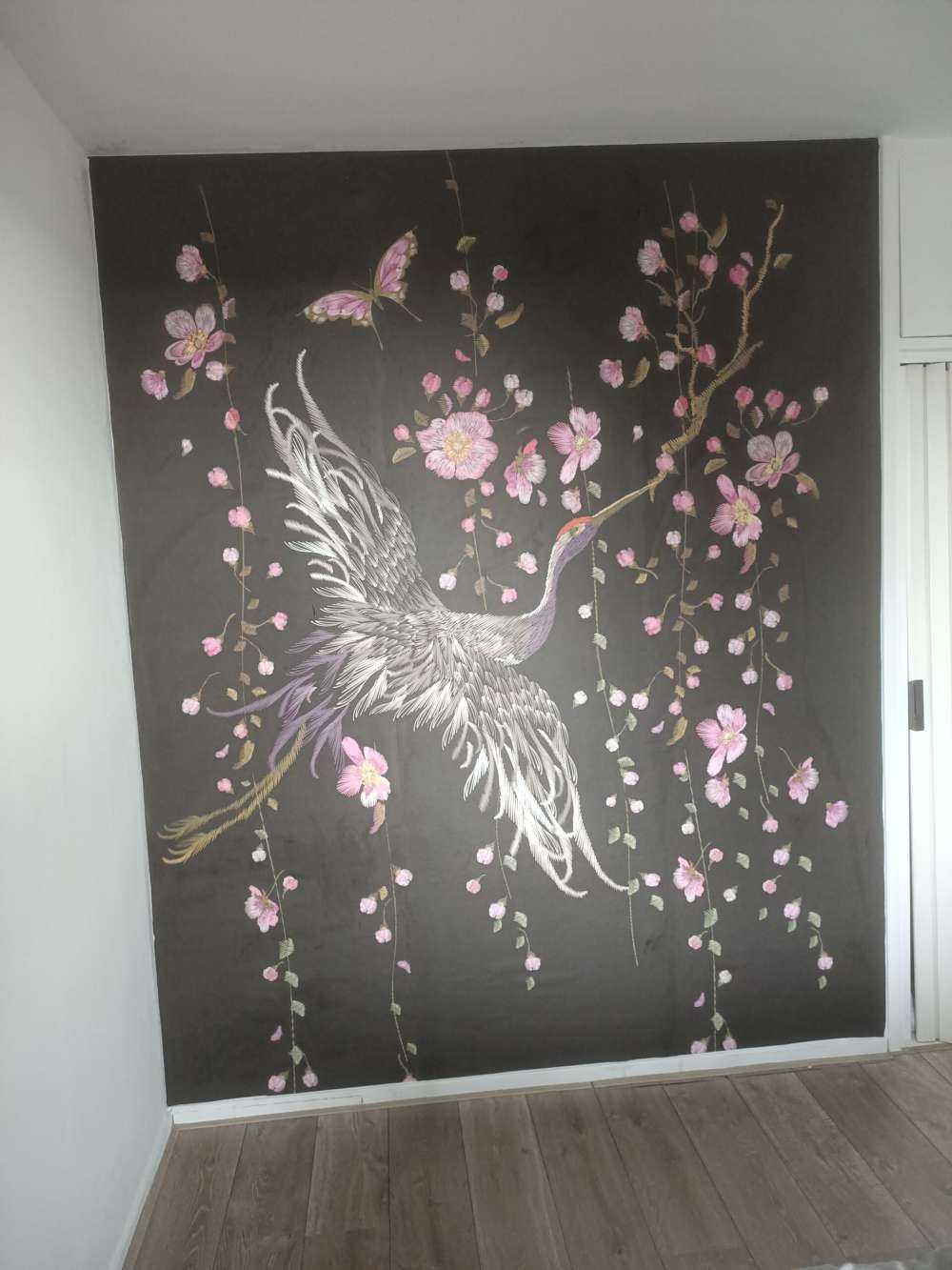 Kraanvogel bij roze bloemen