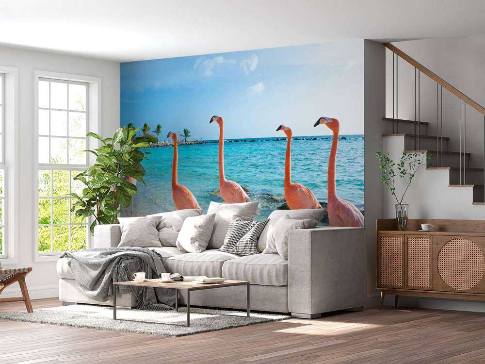 Rij van flamingo's op het strand