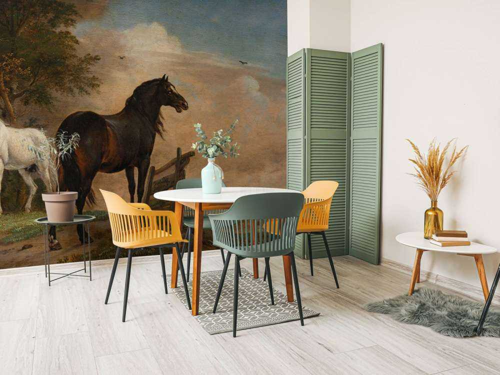 Twee paarden in de weide bij een hek