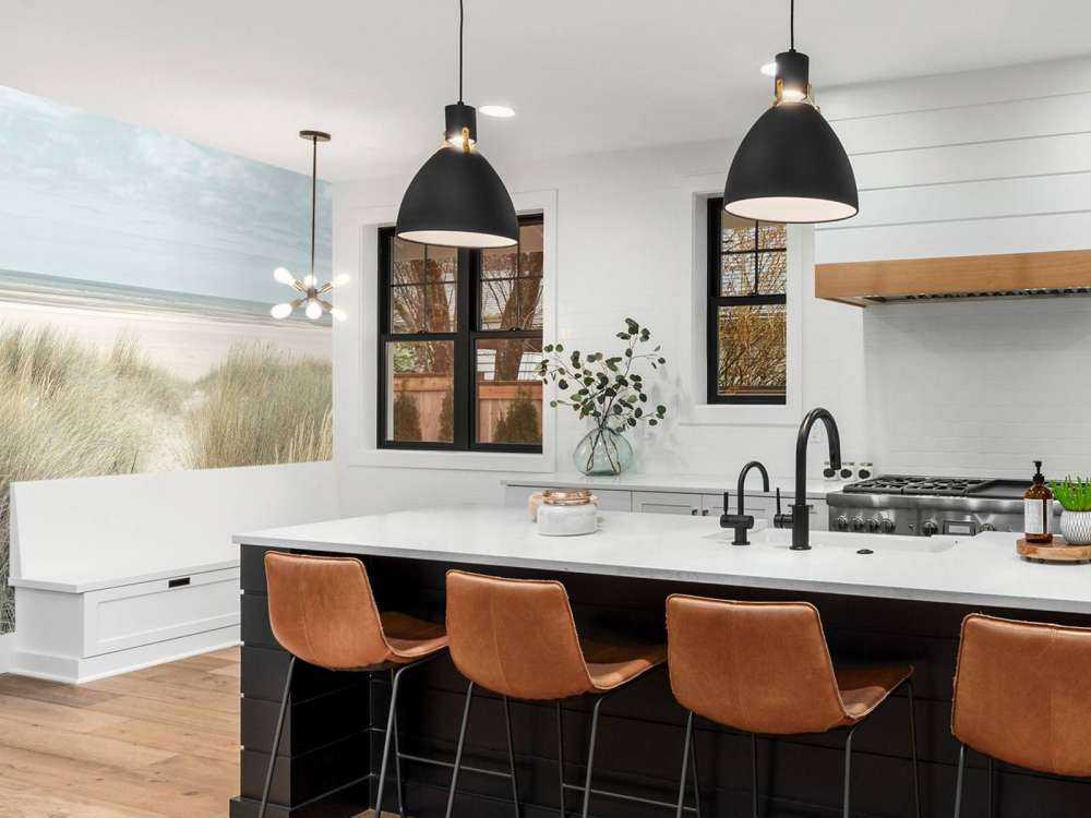 Grassy sand dunes on the sea coast under blue sky