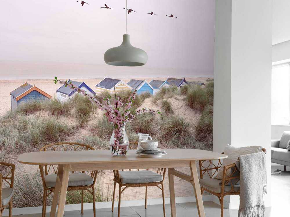 Beach huts on sandy seashore