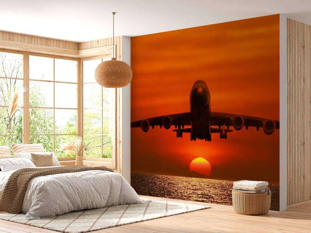 Passagiersvliegtuig boven de zee bij zonsondergang