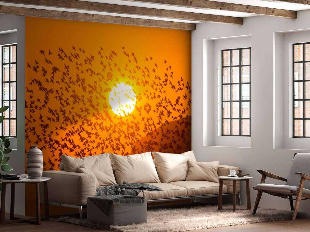 Grote groep vogels bij zonsondergang