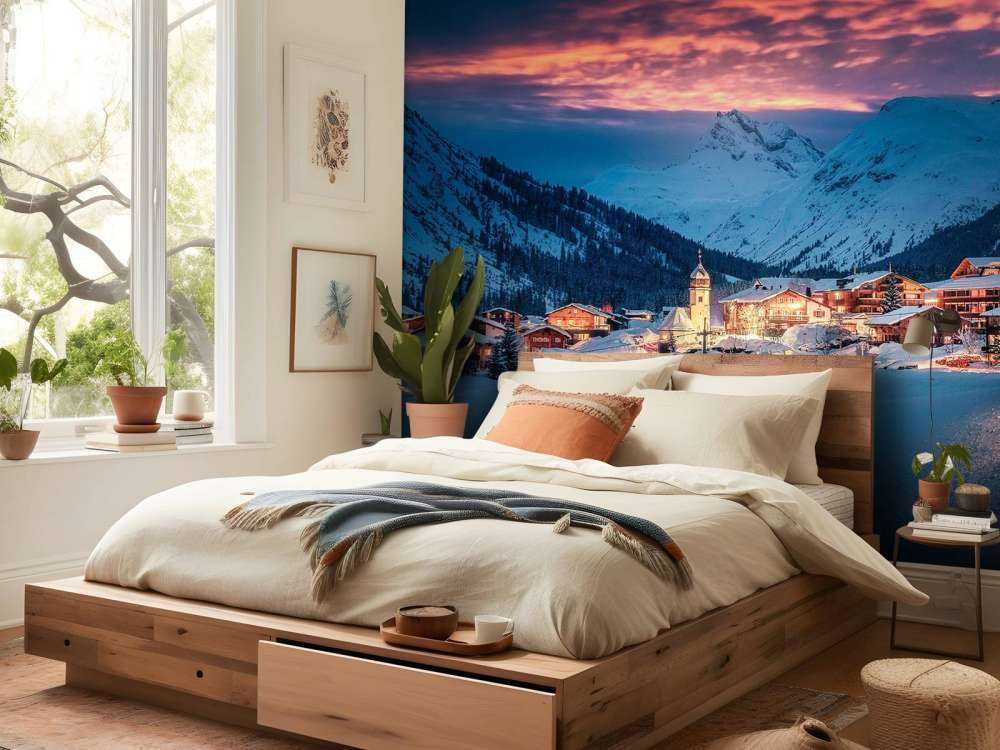 Avondlicht over bergdorp in de sneeuw