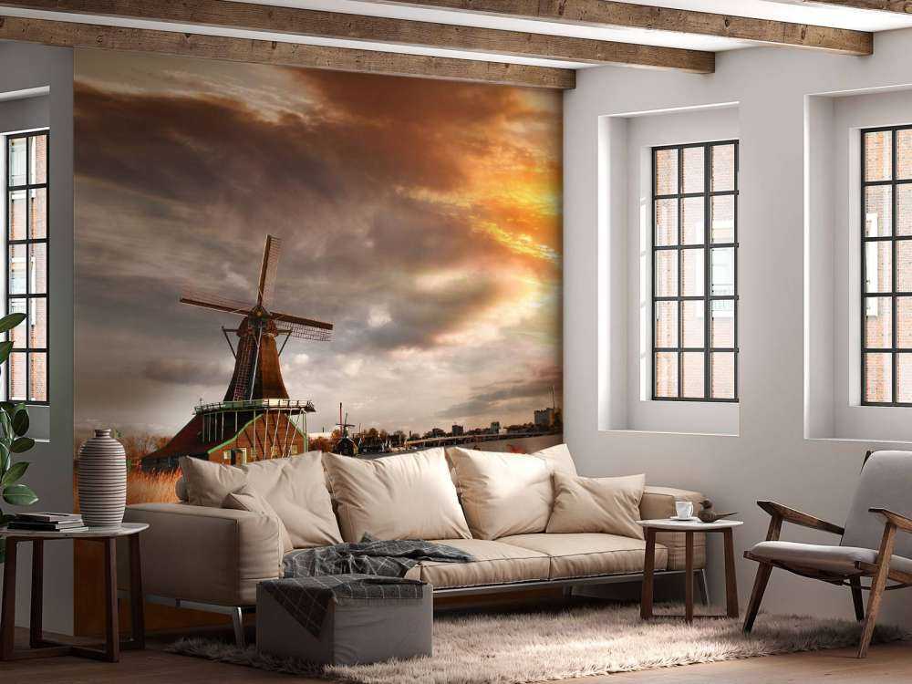 Hollands landschap met molen bij zonsondergang