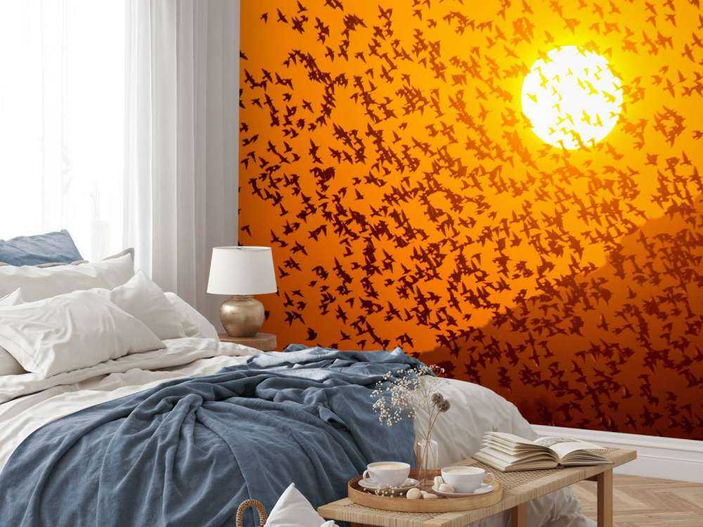 Grote groep vogels bij zonsondergang