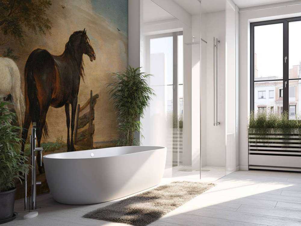 Twee paarden in de weide bij een hek