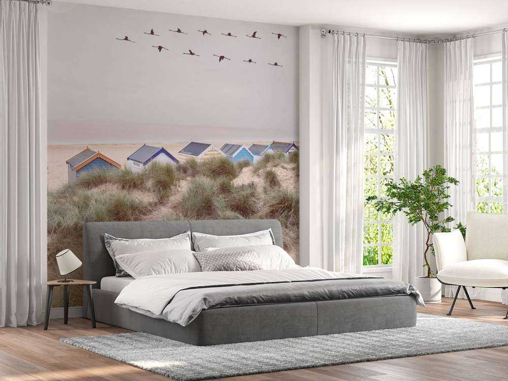 Beach huts on sandy seashore