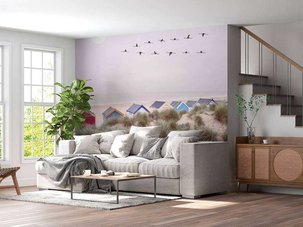 Beach huts on sandy seashore