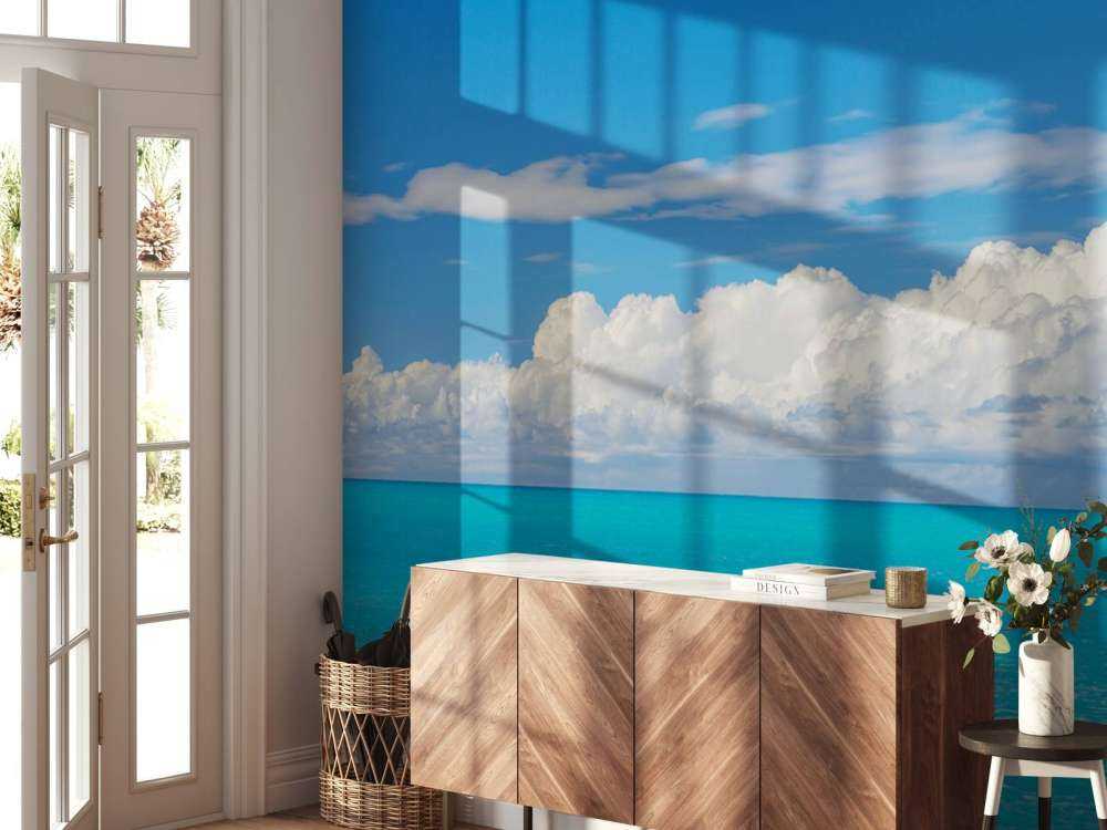 Panoramic view of a blue seascape with sailboat and cloudy sky