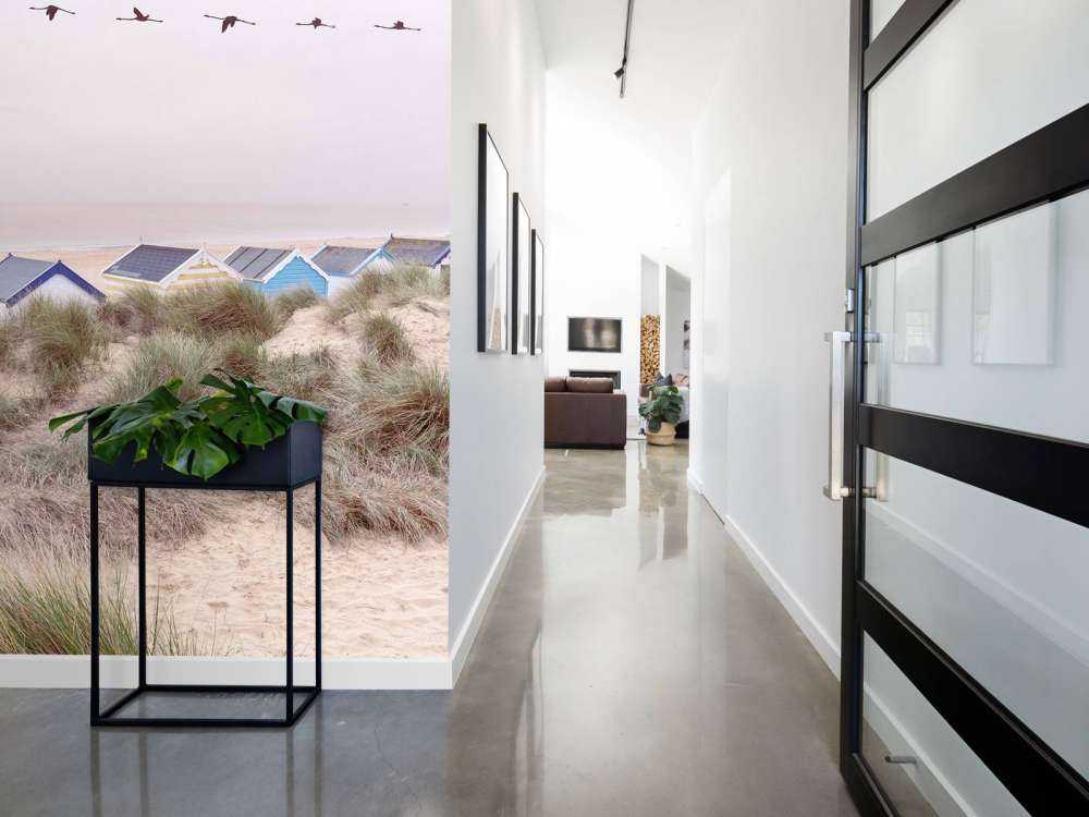 Beach huts on sandy seashore