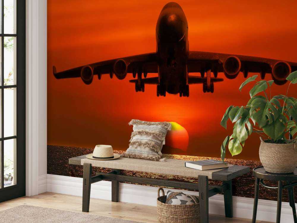 Passagiersvliegtuig boven de zee bij zonsondergang