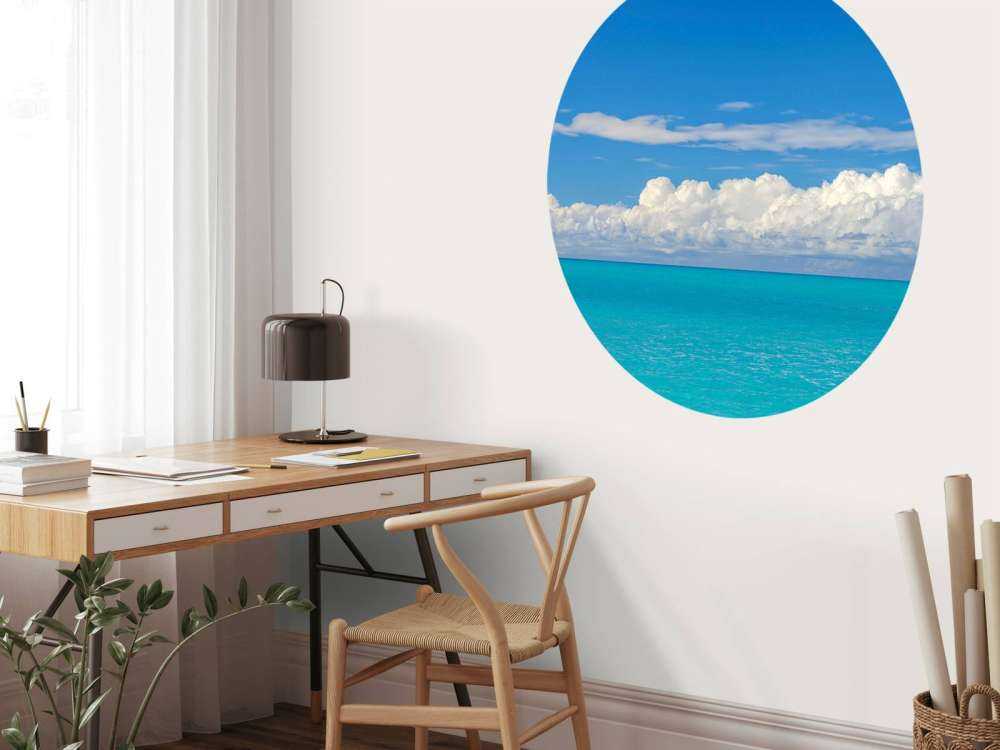 Panoramic view of a blue seascape with sailboat and cloudy sky