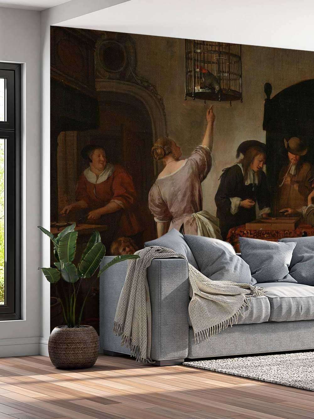 Interieur met een vrouw die een papegaai voert