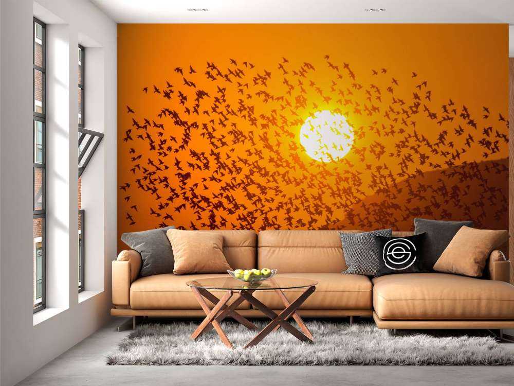 Grote groep vogels bij zonsondergang