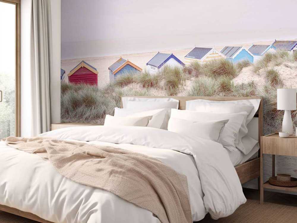 Beach huts on sandy seashore