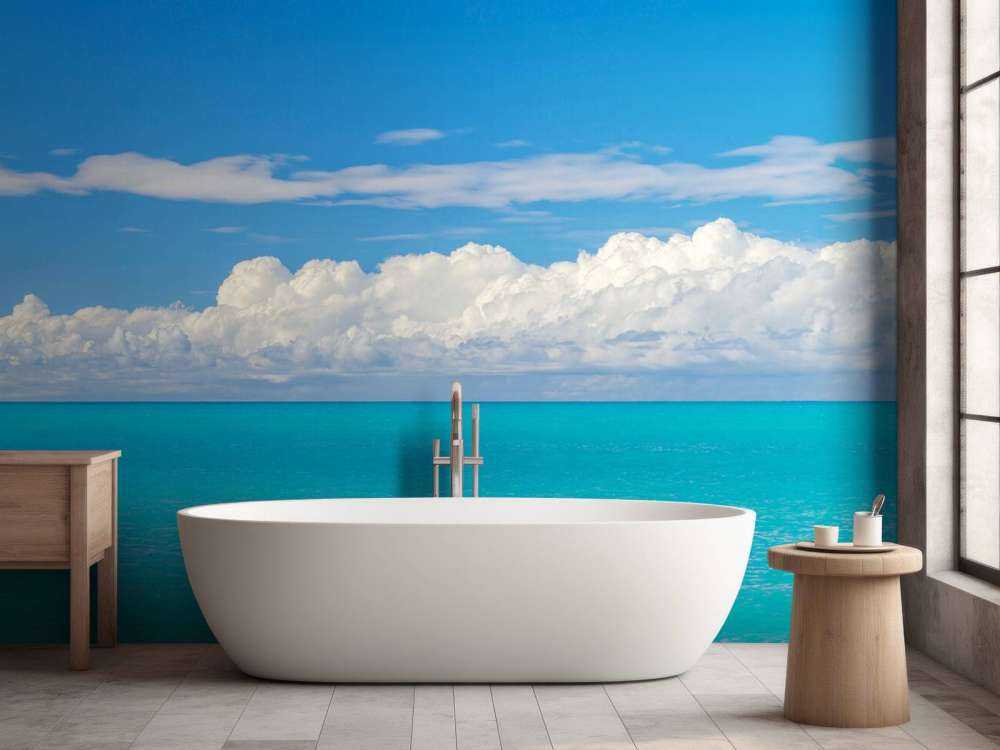 Panoramic view of a blue seascape with sailboat and cloudy sky